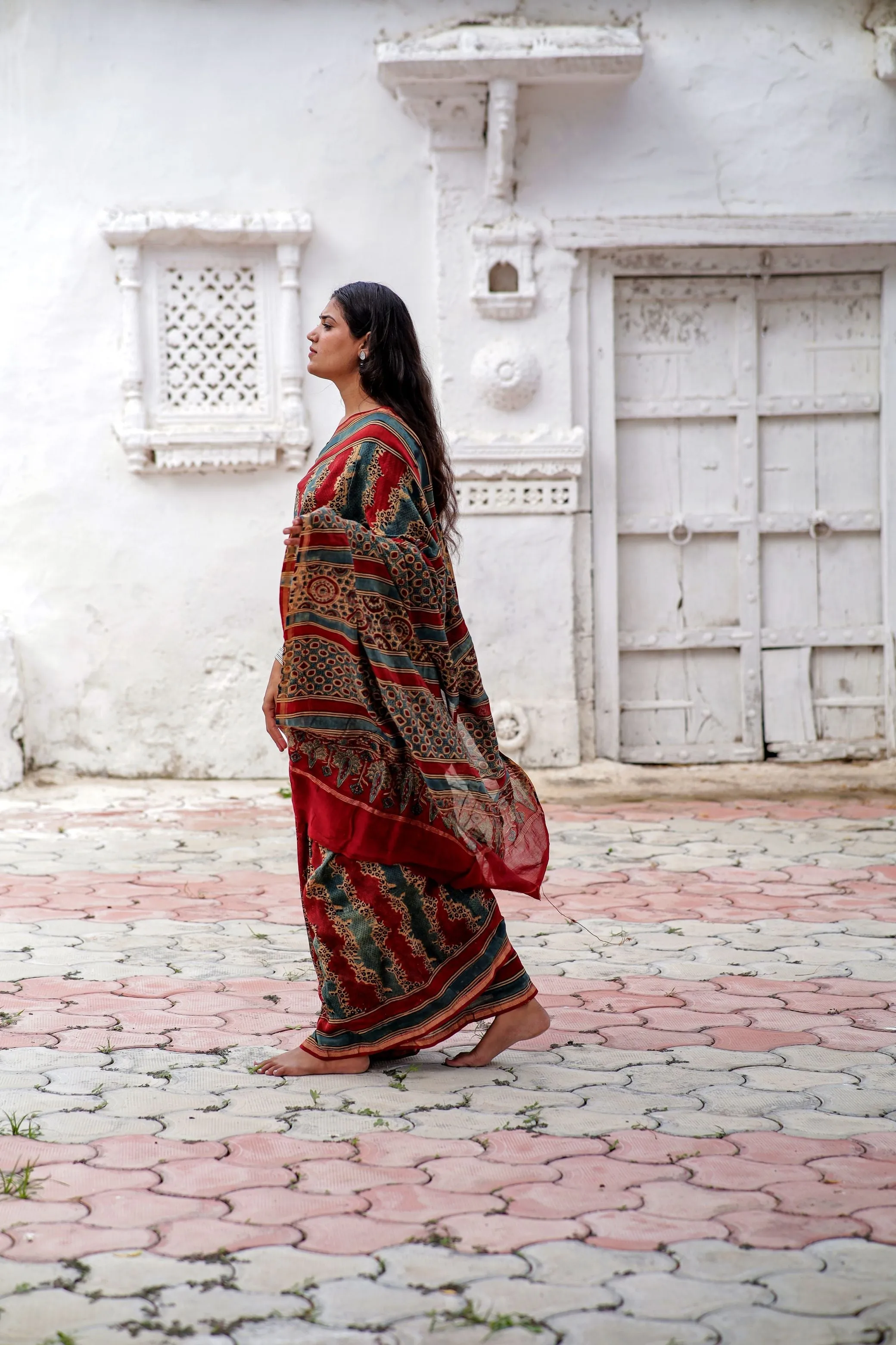 A trsyt with Ajrakh -Jharokha -Geometric Blue and Red Chanderi ajrakh saree